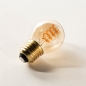 Foto 409-4: LED kogel E27 lichtbron met een warm rookkleurige uitstraling, lichtkleur extra warmwit 2200 kelvin.