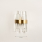 Foto 74984-1: Hotel chique wandlamp in messing met lange prisma's van kristal